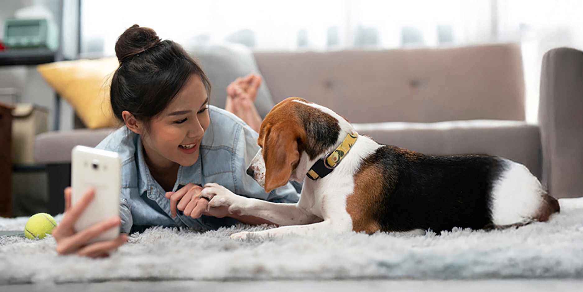 Young woman taking a selfie with her dog.