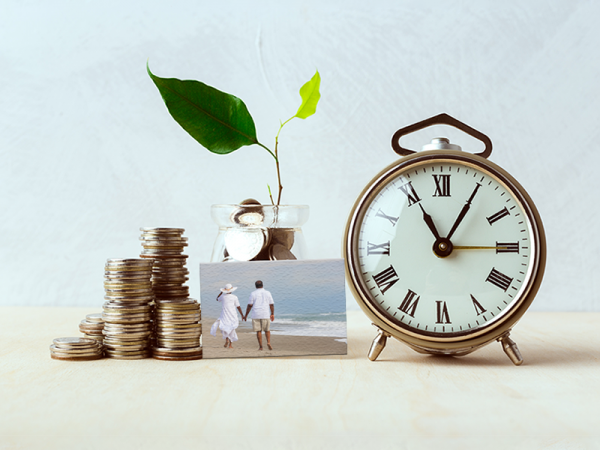 Coins, a picture, a clock, and a plant growing out of a jar of coins