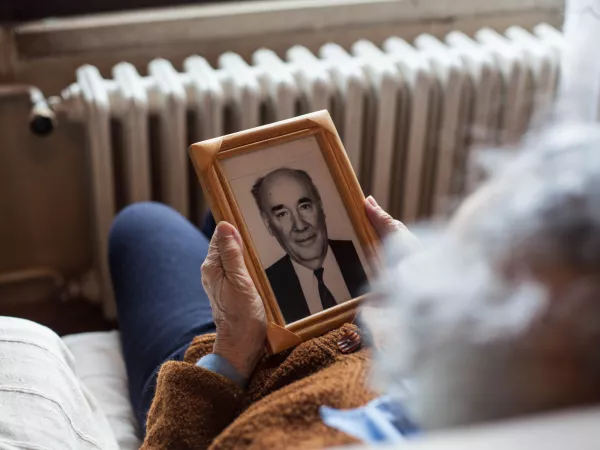 Woman looking at photo of spouse