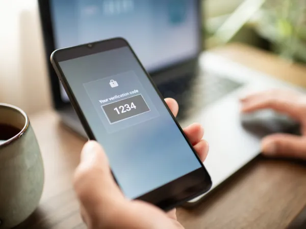 Person holding phone with authentication code