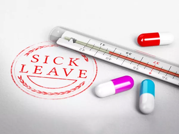 Thermometer surrounded by pills