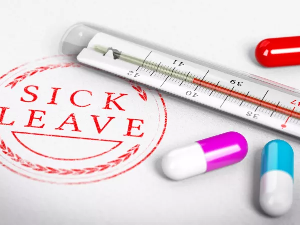 Thermometer surrounded by pills