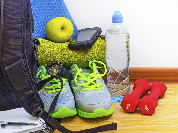 Gym bag with shoes, weights, water bottle and towel