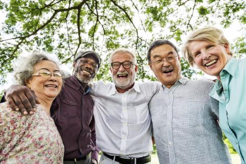 A happy group of five older men and women with diverse racial backgrounds