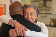 Woman with closed eyes while hugging a man