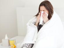 image of woman wrapped up in blanket and ill with the flu