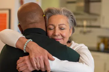 Woman with closed eyes hugging a man