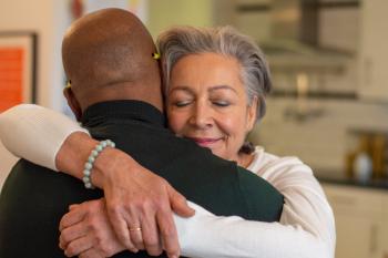 Woman with closed eyes hugging a man